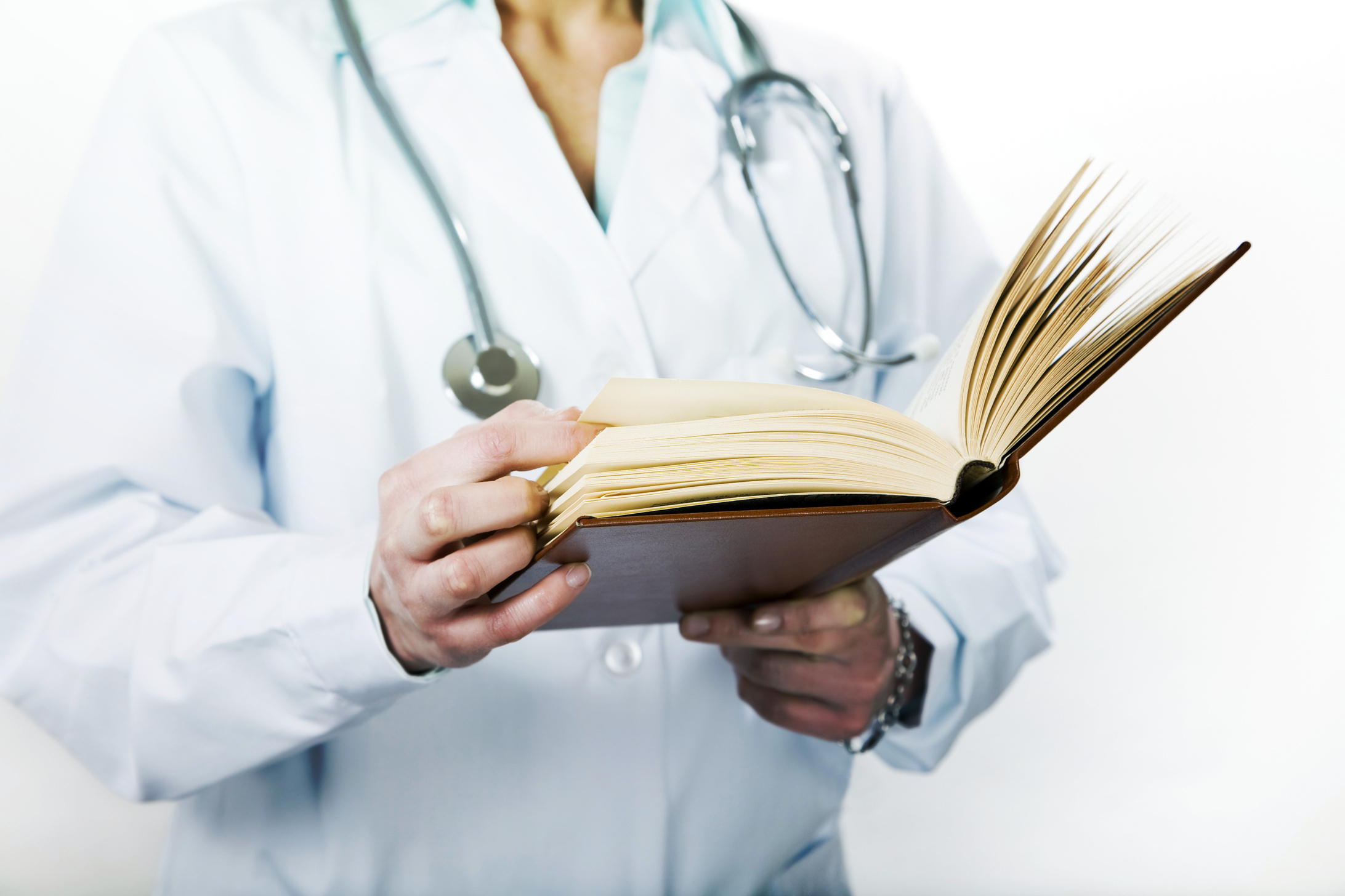 Healthcare and Medicine: Young Doctor Reading a Treatise