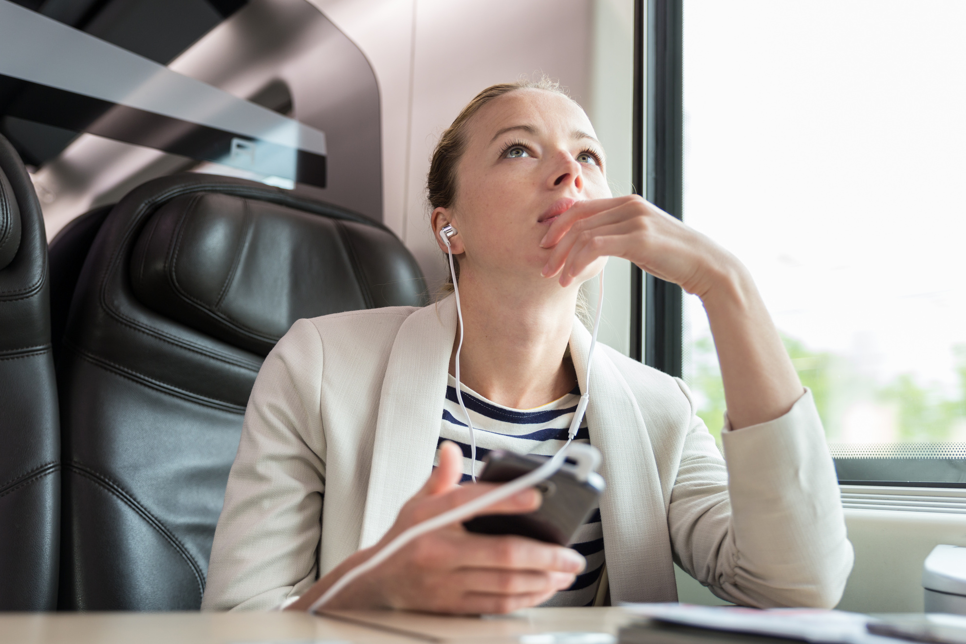 Businesswoman Listening to Podcast on a Train